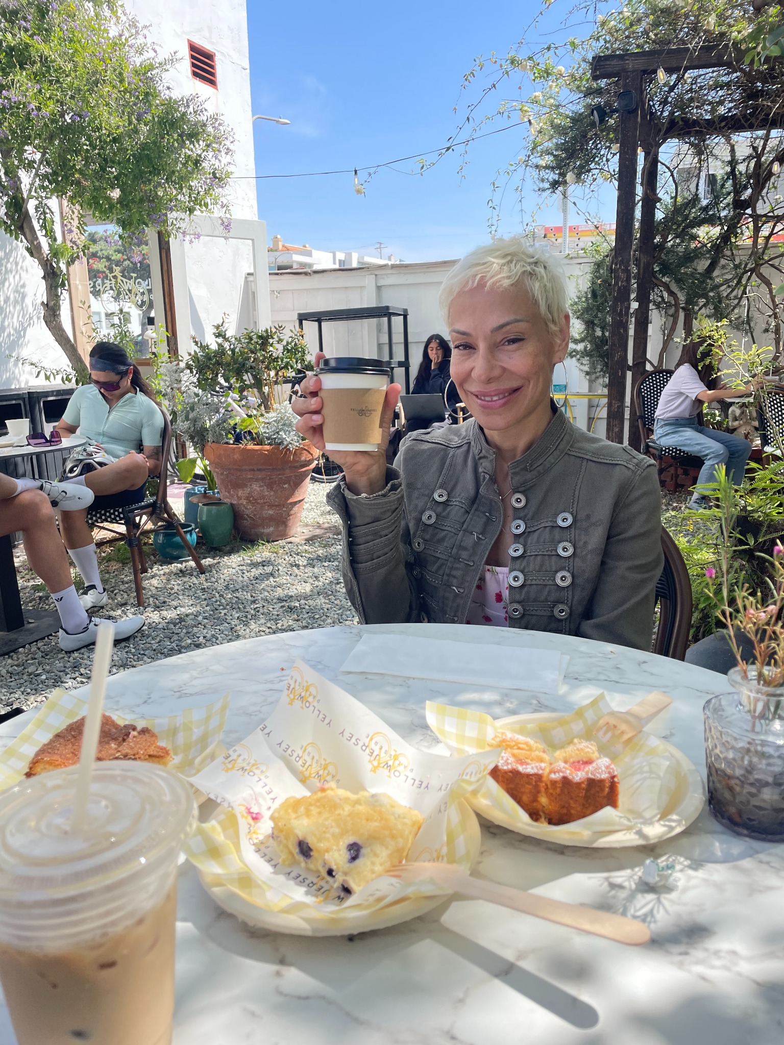 Charis enjoying coffee at a neighborhood table